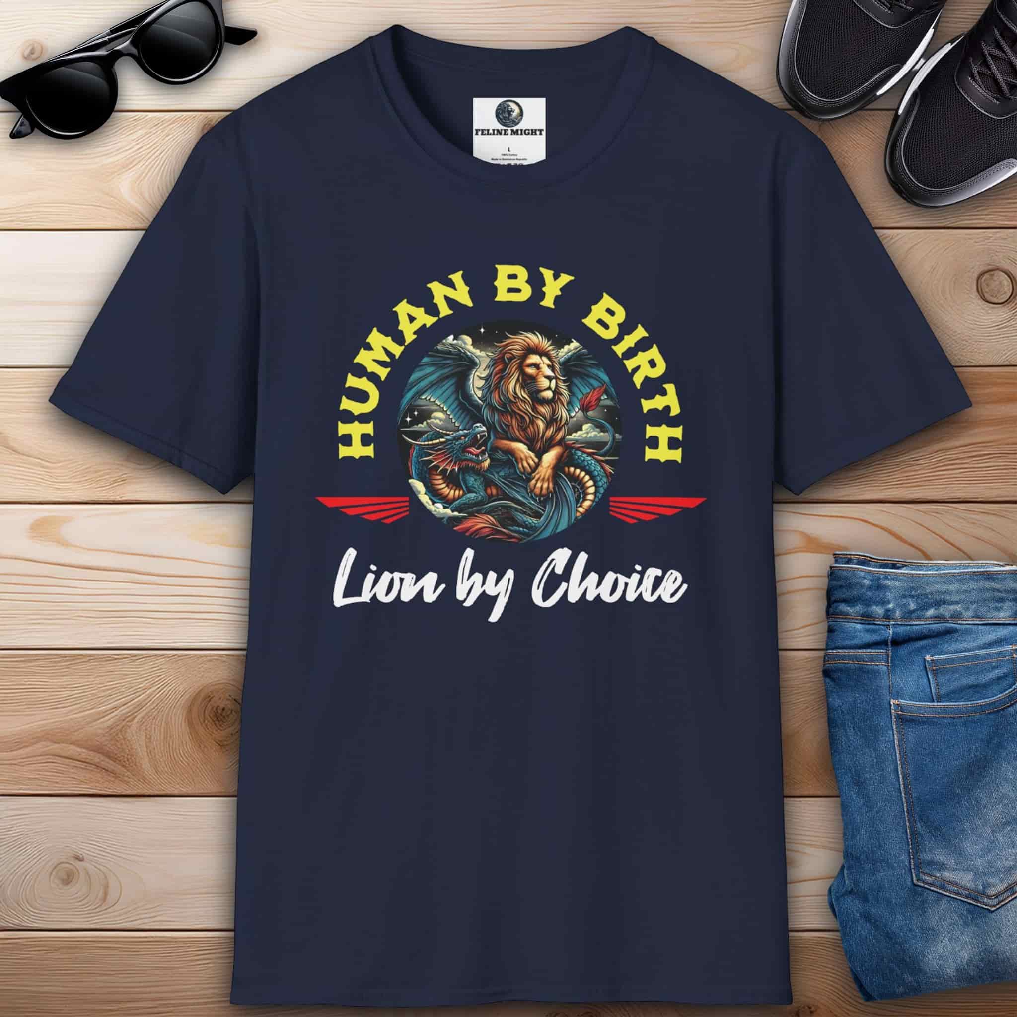 A navy blue Lion Emblem Graphic T-Shirt on a wooden surface, showcasing a bold design for those who lead boldly and never settle for average.