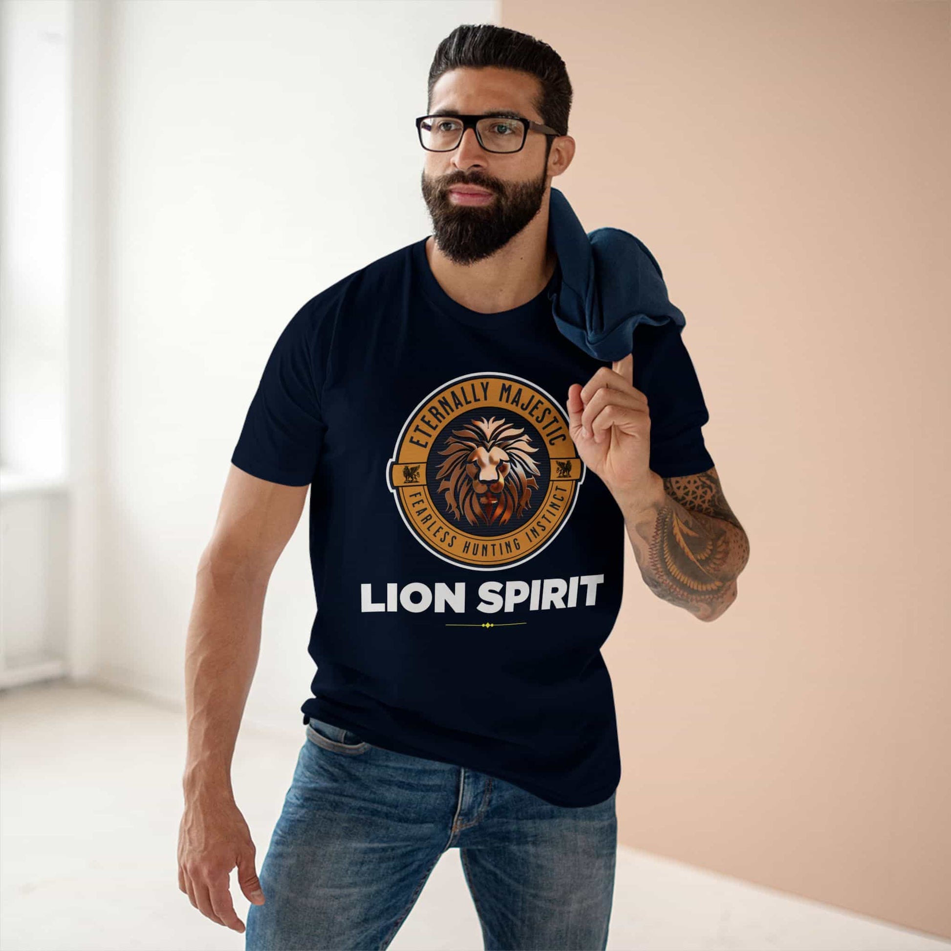 A man wearing a navy blue Lion Spirit T-Shirt with a lion design and the text 'Eternally Majestic, Fearless Hunting Instinct'.