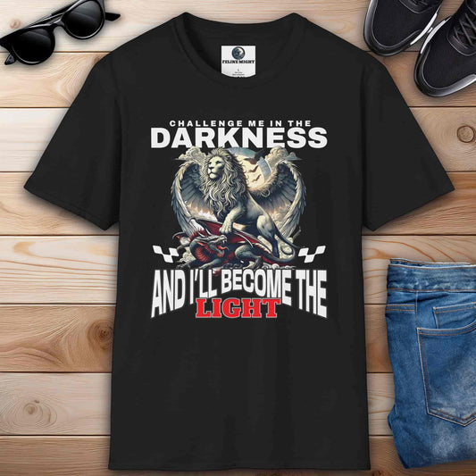Black t-shirt featuring a winged lion graphic with the text 'Challenge me in the darkness and I will become the light.'