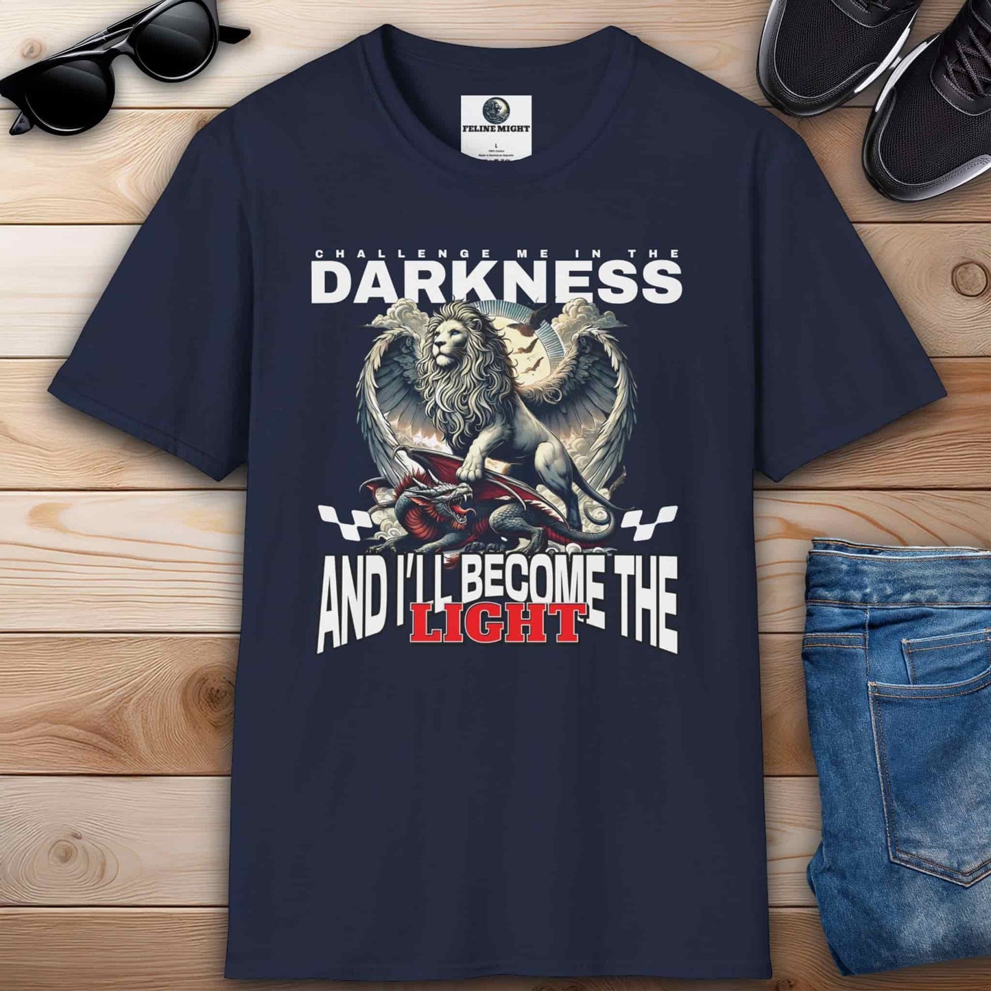 Navy blue t-shirt featuring a lion graphic with the text 'Challenge me in the darkness and I'll become the light.'