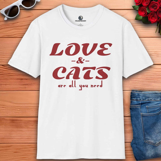 A white graphic t-shirt displaying the message "Love and Cats Are All You Need," emphasizing a passion for felines and affection.