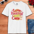 A white "I Love Baking and Cats" T-Shirt with colorful design featuring cats and baking theme.