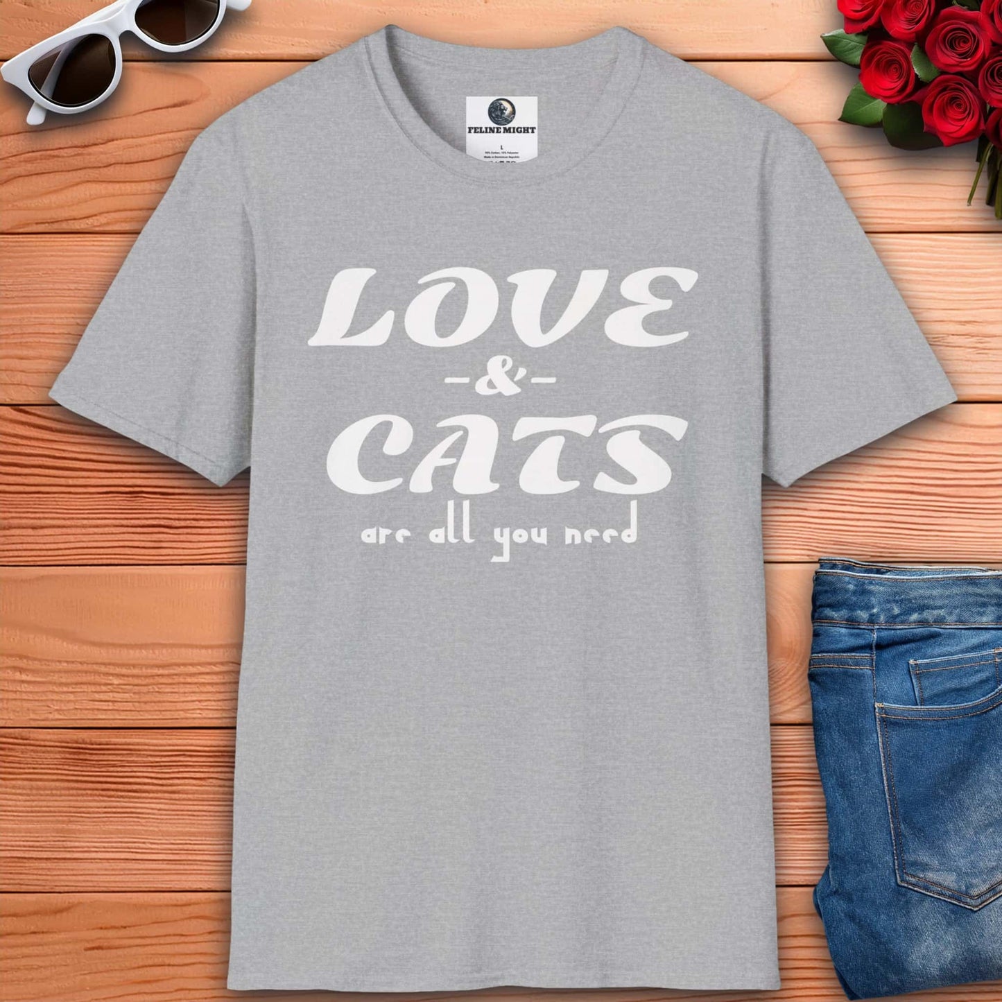 A graphic grey t-shirt displaying the message "Love and Cats Are All You Need," emphasizing a passion for felines and affection.