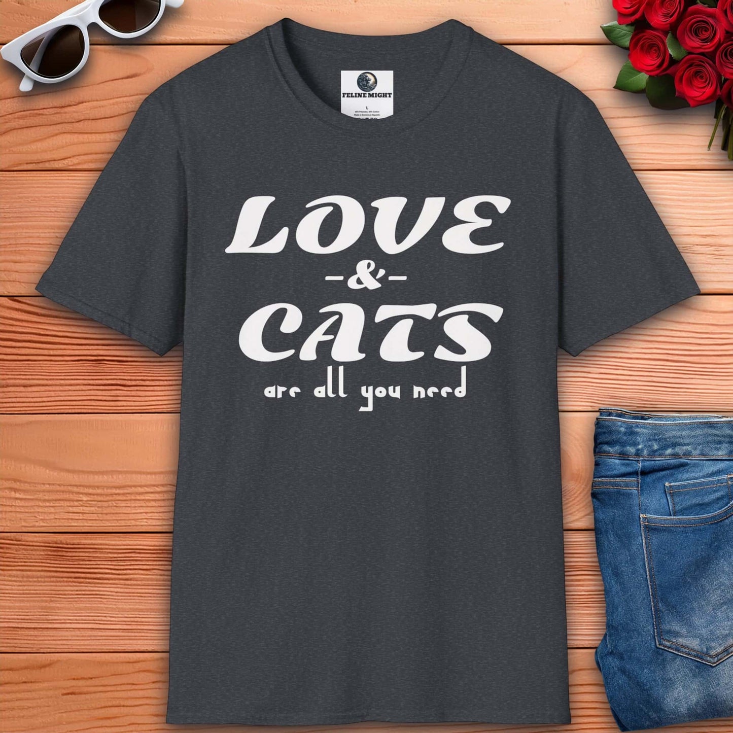 A graphic dark heather grey t-shirt displaying the message "Love and Cats Are All You Need," emphasizing a passion for felines and affection.