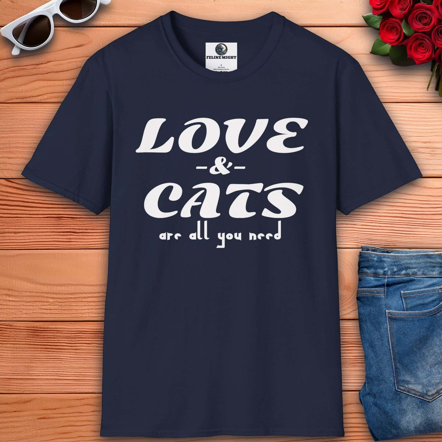 A graphic navy blue t-shirt displaying the message "Love and Cats Are All You Need," emphasizing a passion for felines and affection.