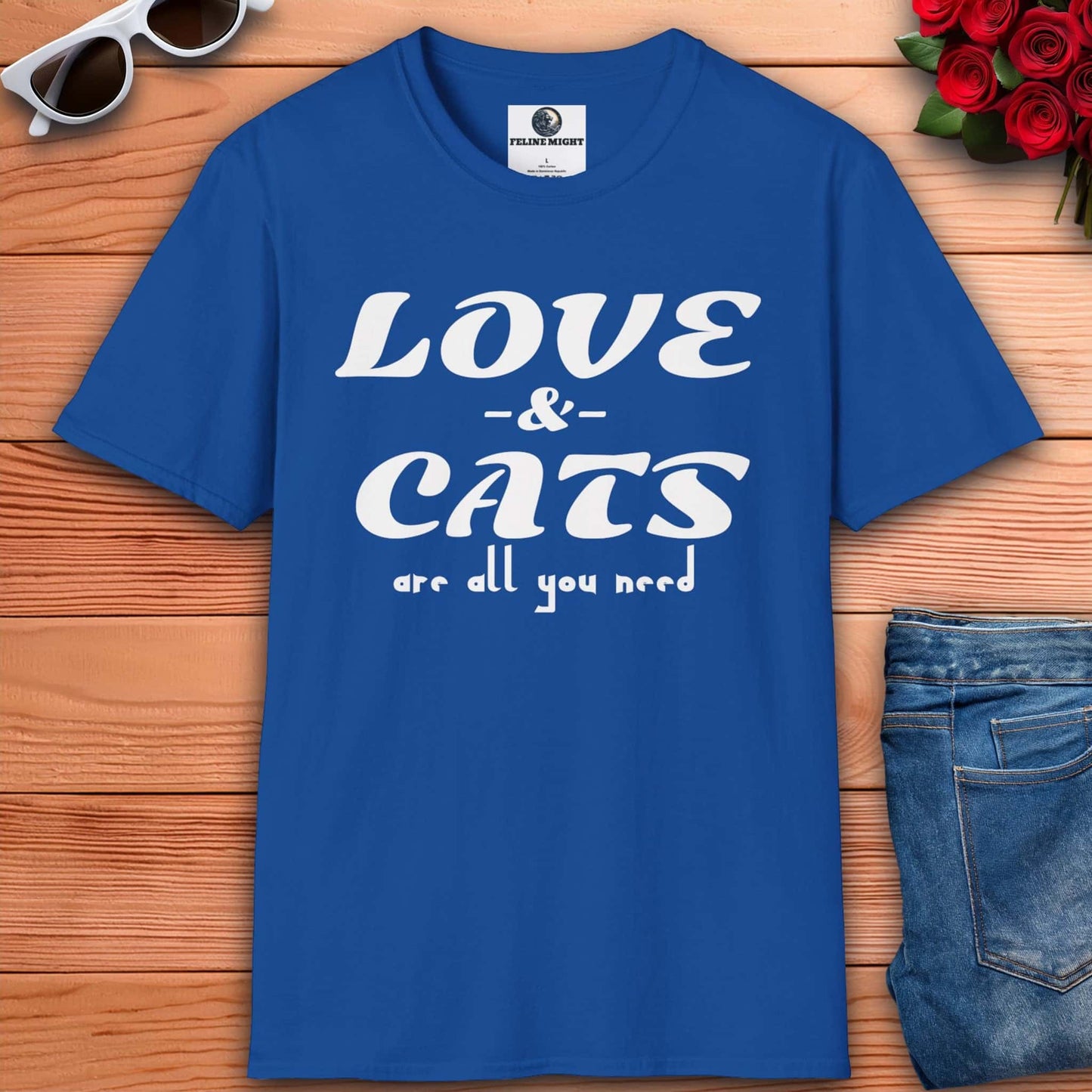 A graphic royal blue t-shirt displaying the message "Love and Cats Are All You Need," emphasizing a passion for felines and affection.