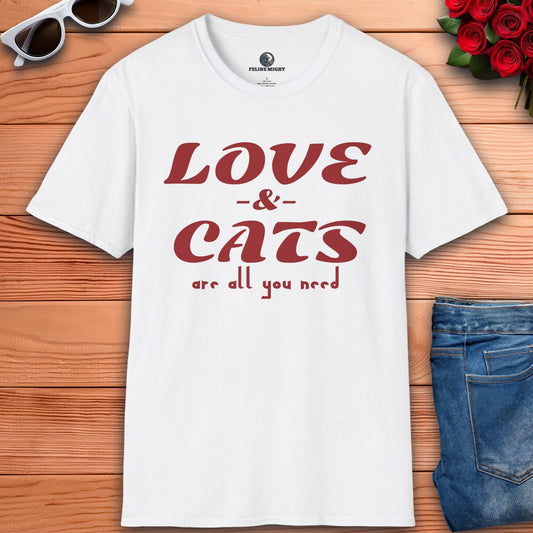 A graphic white t-shirt displaying the message "Love and Cats Are All You Need," emphasizing a passion for felines and affection.