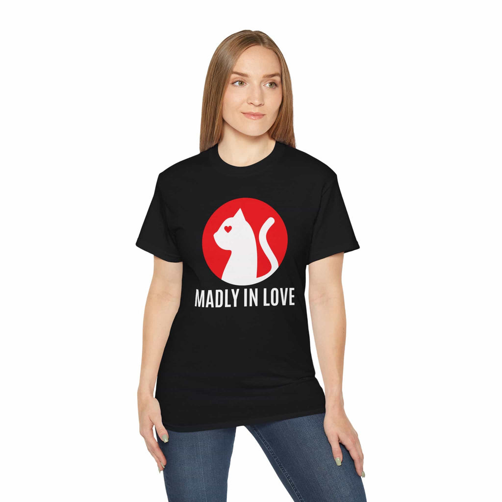 A woman wearing a black Madly in Love Cat T-Shirt featuring a cat silhouette on a red circle, a perfect romantic gift for cat lovers.	