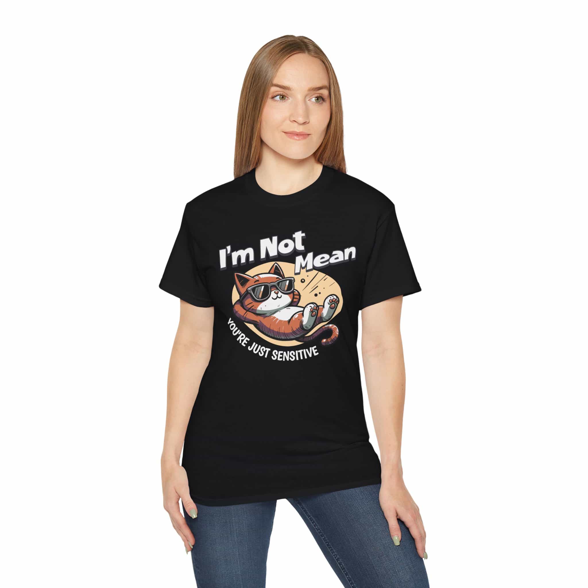 A woman wearing a black Sarcastic Cat Humor T-Shirt with a graphic of a cat wearing sunglasses and the text 'I'm Not Mean, You're Just Sensitive'.