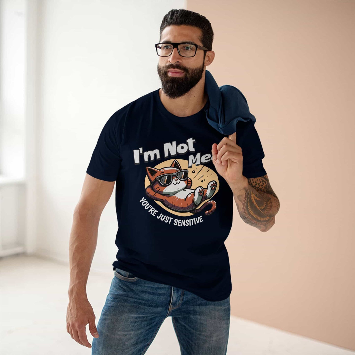 A man wearing a navy blue Sarcastic Cat Humor T-Shirt with a graphic of a cat wearing sunglasses and the text 'I'm Not Mean, You're Just Sensitive'.