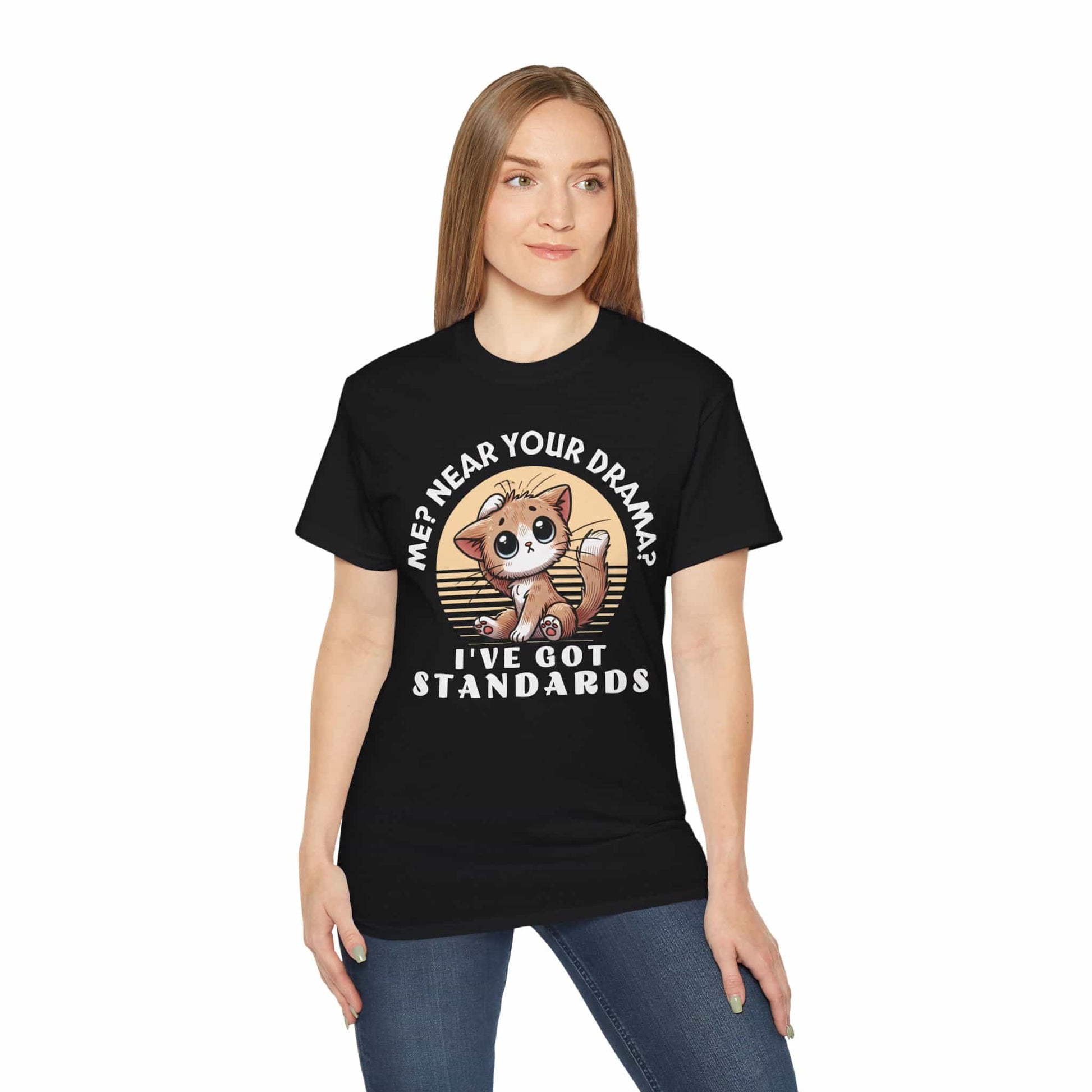 A woman in a black Sassy Cat Funny T-Shirt featuring a humorous design with a cute cat and text saying 'Me? Near Your Drama? I've Got Standards.'