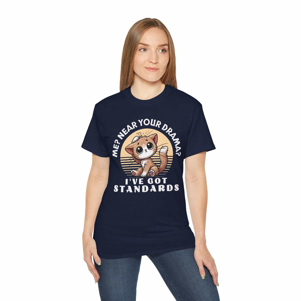 A woman in a navy blue Sassy Cat Graphic T-Shirt featuring a humorous design with a cute cat and text saying 'Me? Near Your Drama? I've Got Standards.'