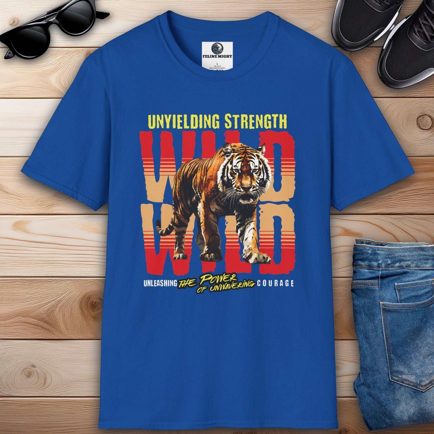 Royal blue T-shirt featuring a tiger graphic with the text 'Unyielding Strength' and 'Wild' on a wooden background.