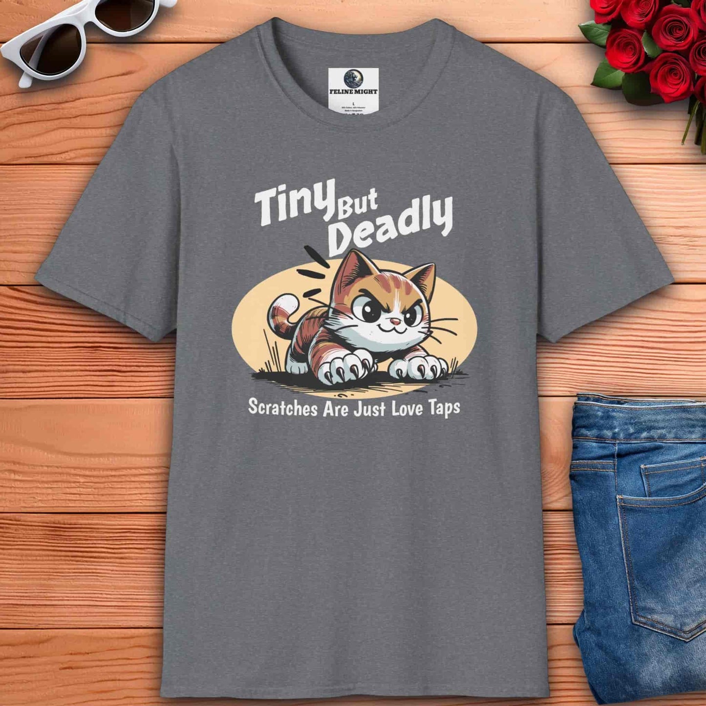 Athletic heather grey t-shirt featuring a playful cat graphic with the phrase 'Tiny But Deadly' and 'Scratches Are Just Love Taps'.