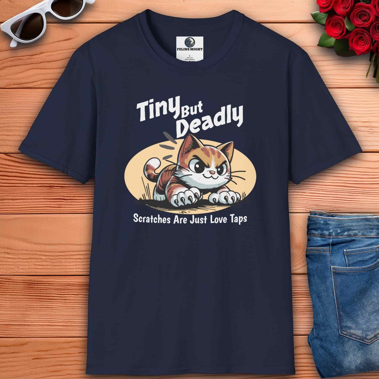 Navy blue t-shirt featuring a playful cat graphic with the phrase 'Tiny But Deadly' and 'Scratches Are Just Love Taps'.