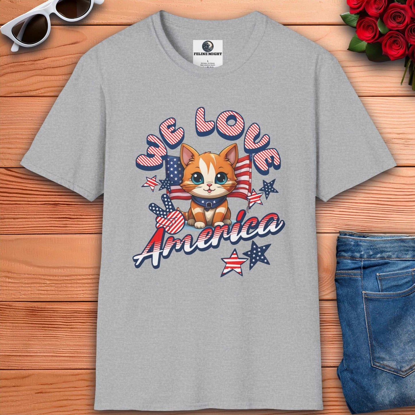 Grey t-shirt featuring cute cat design with 'We Love America' text and patriotic elements