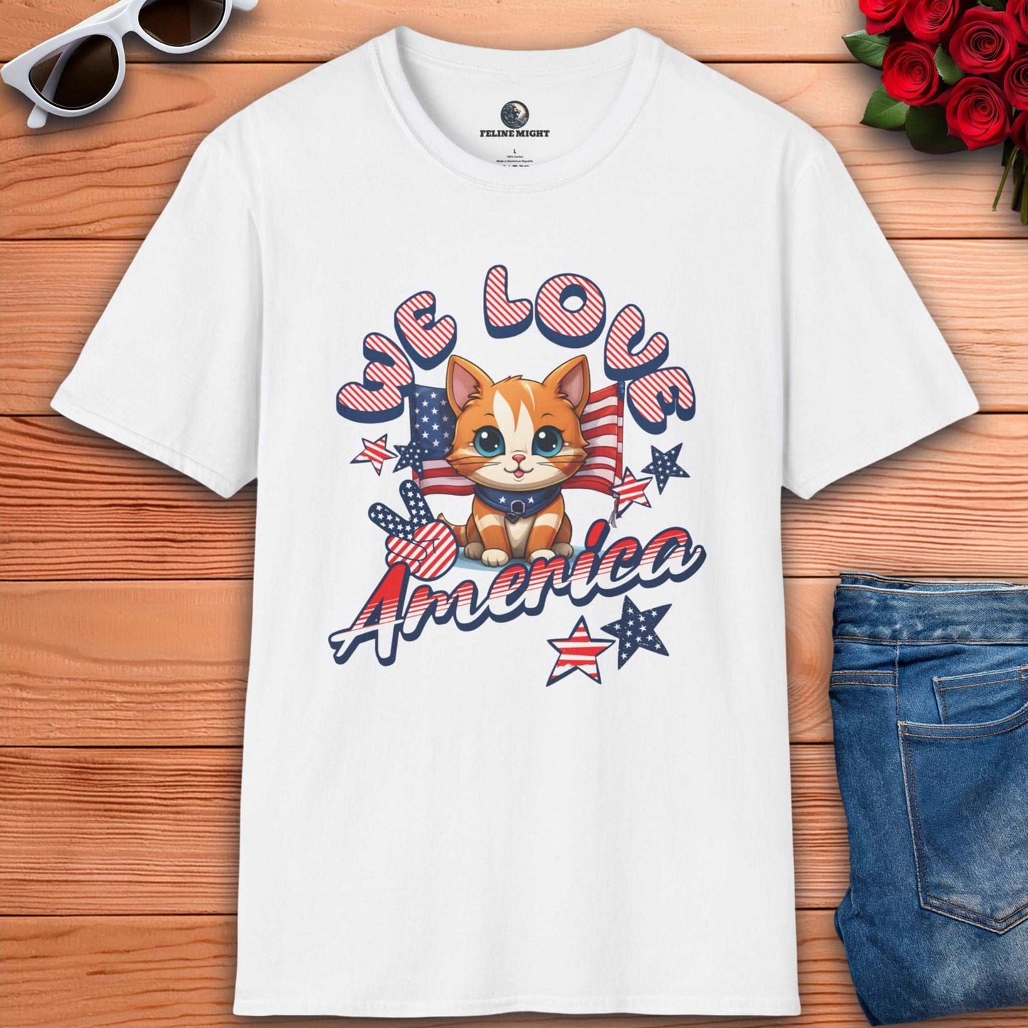 White t-shirt featuring cute cat design with 'We Love America' text and patriotic elements