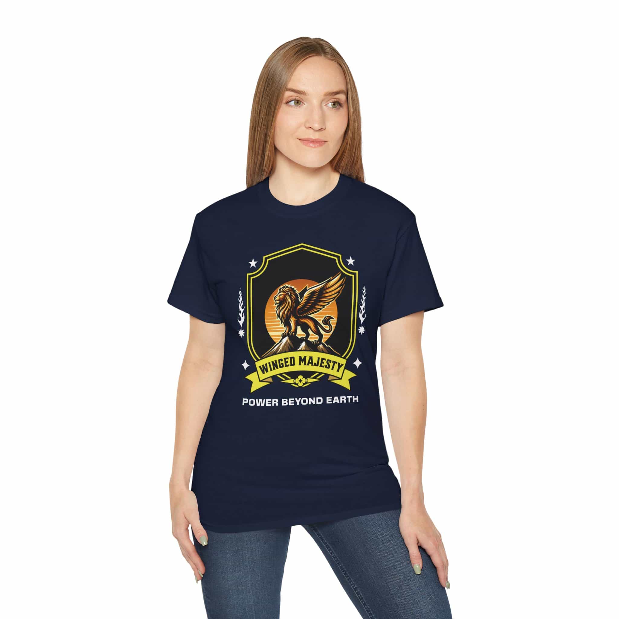 A woman wearing a navy blue Winged Majesty Lion T-Shirt featuring a golden-winged lion graphic and the text 'Power Beyond Earth'.